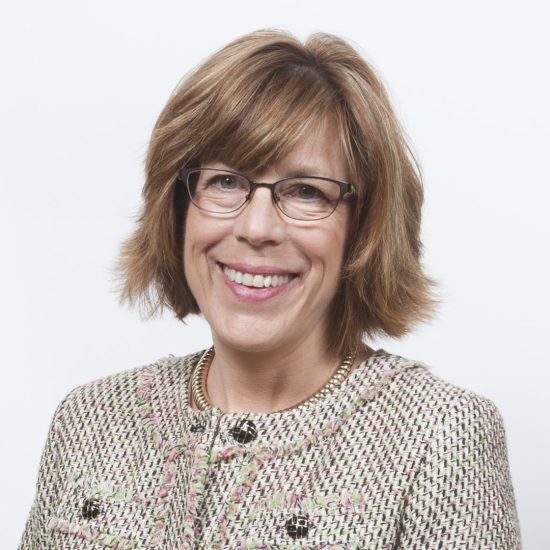 A woman poses for a professional photo.