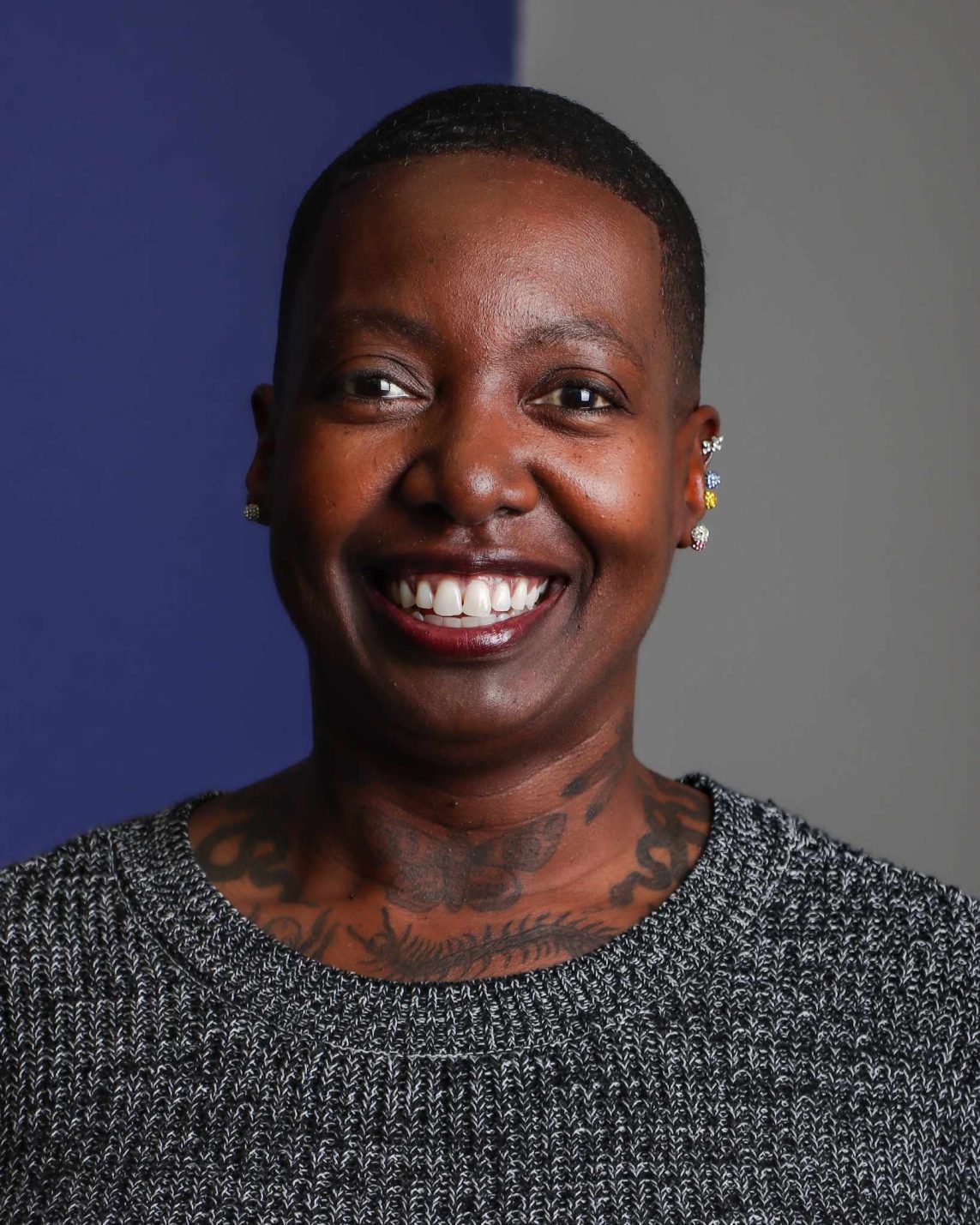 A woman smiles big for a headshot photo.