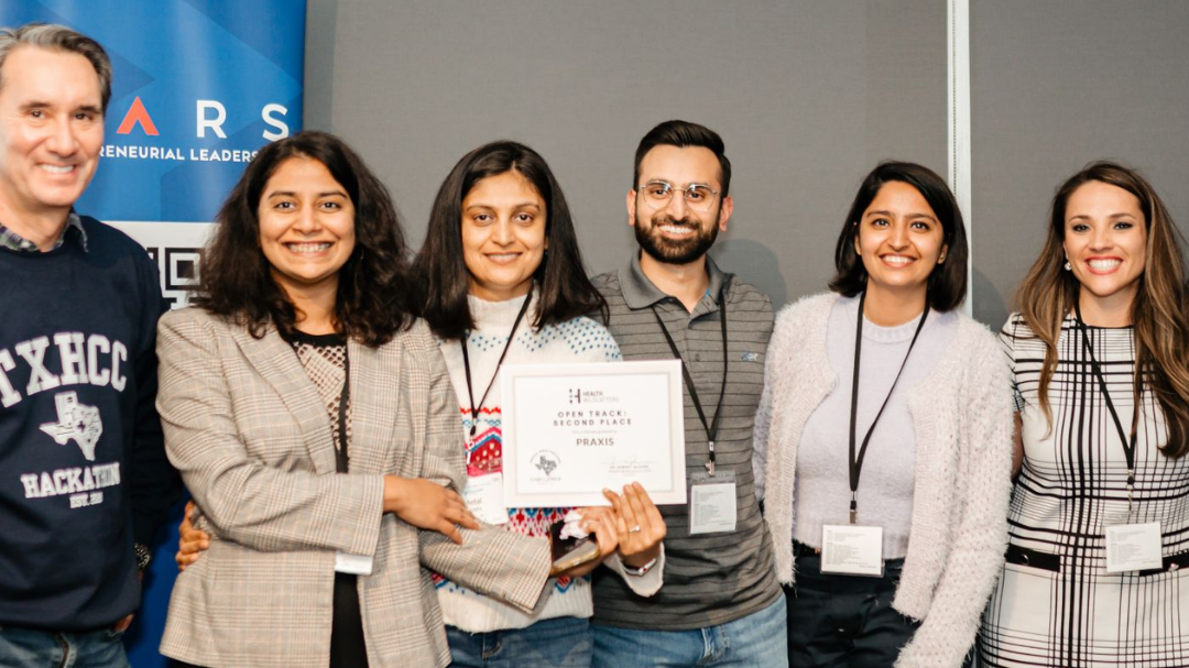 A group of people pose for a photo with a certificate.