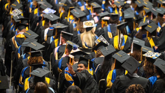 A crowd of college graduates during a graduation ceremony.