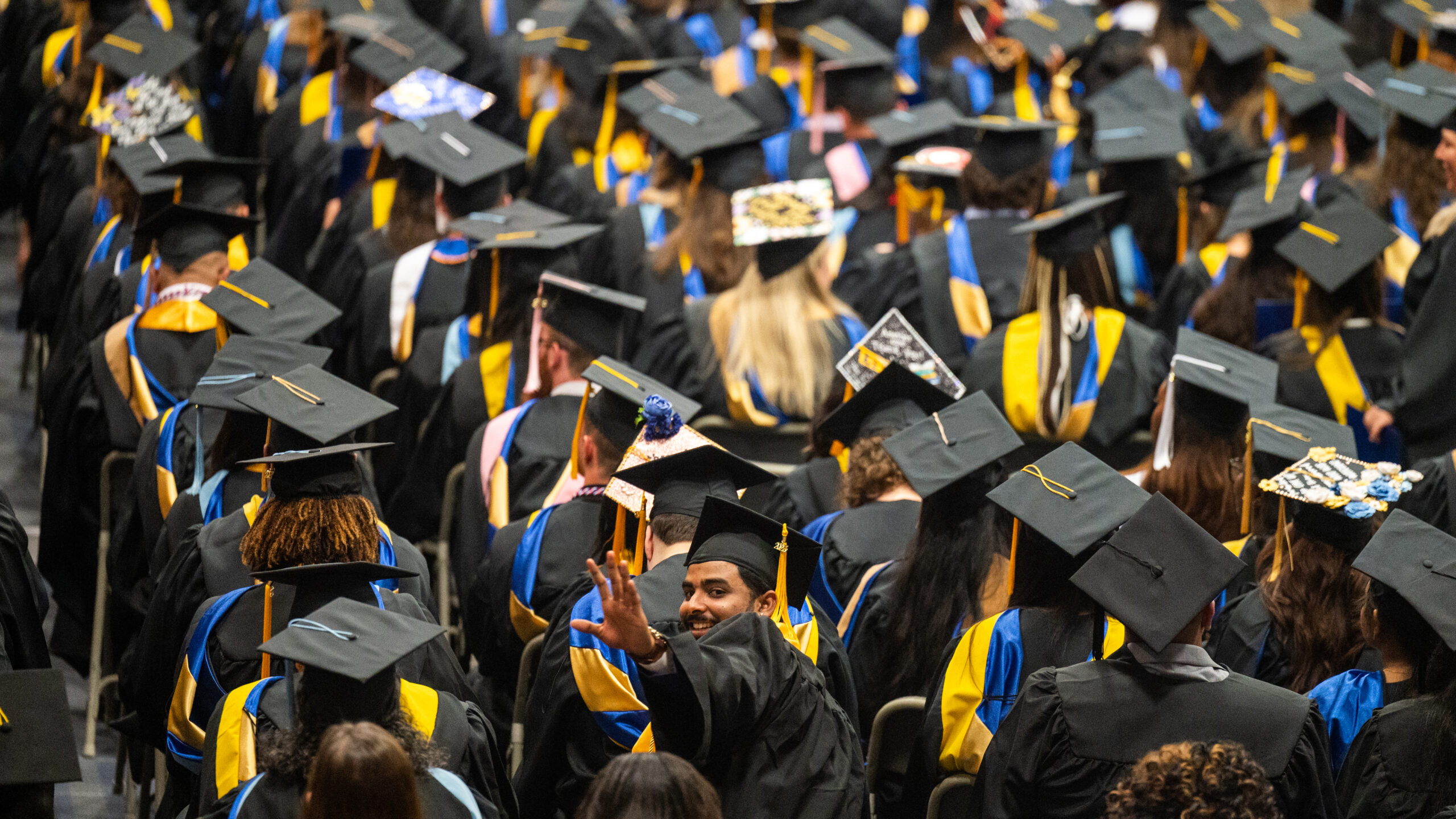 A crowd of college graduates during a graduation ceremony.